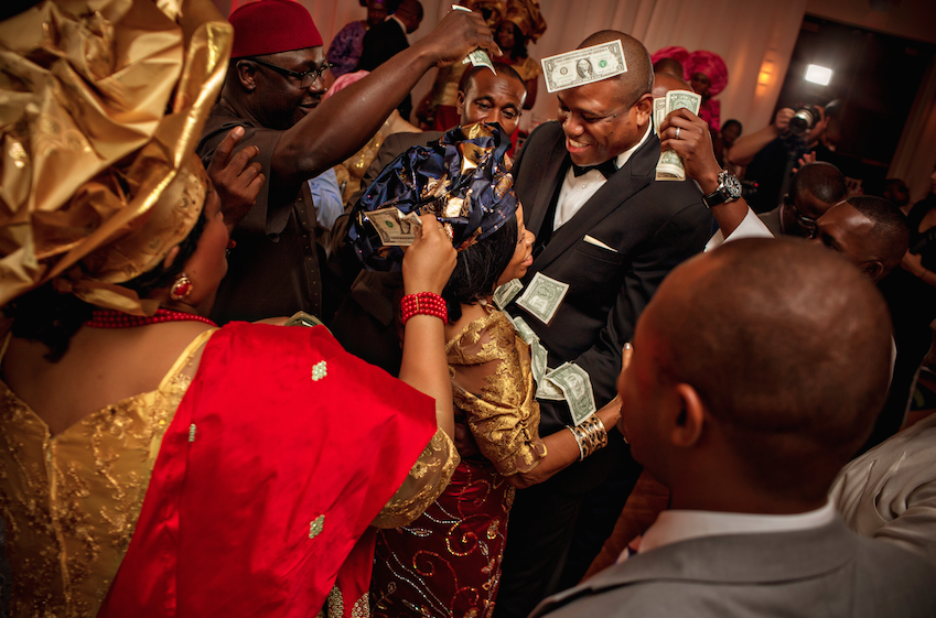 guests throwing money nigerian wedding